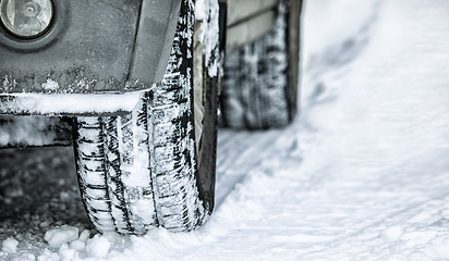 Image showing Tire, winter and car in danger on snow or ice for a road trip, travel and outdoor journey using transport in cold weather. Closeup of ice, transportation and vehicle driving on a track in nature