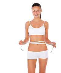 Image showing Happy woman, portrait and tape measure for lose weight or diet against a white studio background. Isolated fit or slim female model in underwear or lingerie smiling for healthy body or wellness