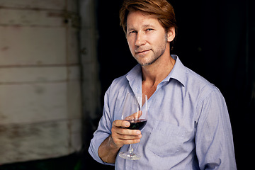 Image showing Portrait, wine tasting and a man in the cellar of a vineyard on a farm for the production or fermentation of alcohol. Glass, distillery and a male farmer drinking a beverage for quality control