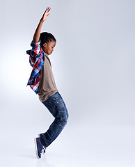 Image showing Dance, hip hop and young child dancer dancing isolated in a white studio background in a pose feeling excited. Talent, mockup and kid or child with energy and skill ready for breakdance performance