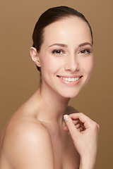 Image showing Portrait, smile and woman with beauty, dermatology and grooming against a brown studio background. Face, female person and happy model with cosmetics, organic facial and salon treatment with skincare