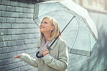 Image showing Rain umbrella, city street and woman smile with happiness on a sidewalk from winter weather. Happy female person, raining and travel on a urban road in New York on holiday with freedom and joy