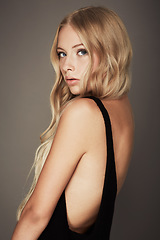 Image showing Seductive, face and beauty portrait of a woman with makeup, cosmetics and long hair in studio. Headshot of a female aesthetic model with a skin glow, luxury skincare and fashion on a grey background