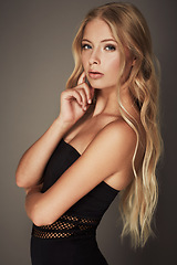 Image showing Beauty, face and portrait of a woman in studio with makeup, cosmetics and long hair. Headshot of a female aesthetic model with a natural glow, sexy style and seductive pose on a grey background