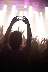 Image showing Streaming, concert and hands of audience with phone for pictures, celebration and enjoying stage, music or event. Party, people and performance with excited fans showing support, passion or recording