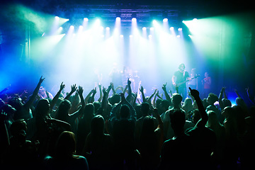 Image showing Music, dance and party with crowd at concert for rock, live band performance and festival show. New year, celebration and disco with audience of fans listening to techno, rave and nightclub event