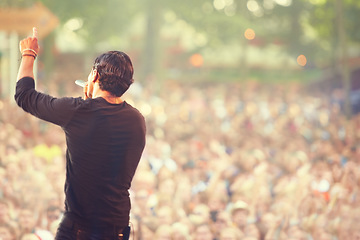 Image showing Music, microphone and singer with man at concert for rock festival, performance and party in nature. Celebration, energy and audience with male musician on stage for club, show and event in outdoors