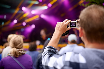 Image showing Music, camera and party with man at festival for stage picture, social media and summer. Techno, photography or streaming at rave with male photographer in crowd for carnival, energy and rock event