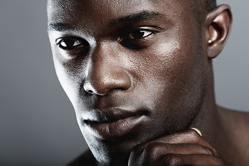 Image showing Beauty, skin care and face of black man on dark background with male cosmetics, strong and serious glow closeup. Health, wellness and dermatology, African skincare model isolated on studio backdrop.