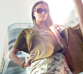 Image showing Shopping bag, city portrait and confident woman with fashion clothes purchase, retail product or store discount. Pride, sales spree and chic female customer with sunglasses, luxury brand or mall gift