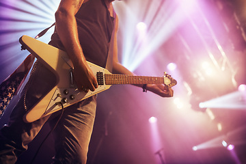 Image showing Guitar, man and performance for concert, rock or singing at party, event or celebration in night. Male musician, artist or rockstar with instrument at music festival for art, sound or talent on stage