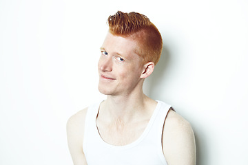 Image showing Happy, ginger and portrait of man in studio for casual, red hair and trendy style. Natural, smile and shy with face of male model isolated on white background for confident, pride or mockup