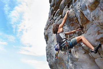 Image showing Rock climbing, fitness and adventure with woman on mountain for challenge and travel with space. Strong, freedom and hiking with female climber training in nature for courage, safety and workout