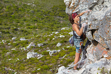 Image showing Rock climbing, freedom and challenge with woman on mountain for adventure, travel and explore. Strong, fitness and cliff with female climber training in nature for courage, safety and workout