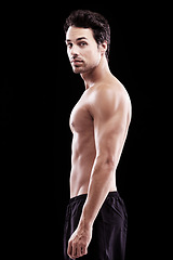 Image showing Portrait, man and body of bodybuilder on black background, dark studio and muscular abdomen. Sexy, serious and strong male model, sports athlete and fitness power for exercise, training and muscle