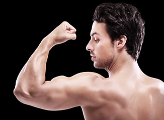 Image showing Back of man, bodybuilder and bicep flex in studio, black background and exercise for power. Strong, sexy and topless male model, sports athlete and arm muscle for pride, training and fitness results