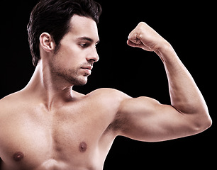 Image showing Man, bodybuilder and bicep flex in studio, black background and exercise for muscular power. Strong, sexy and topless male model, sports athlete and arm muscle for pride, training and fitness results