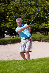 Image showing Sports, portrait and old man with golf club swing outdoor for fitness, training and practice. Face, golfing and senior male golfer swinging driver in a park, serious and enjoying retirement hobby