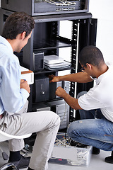 Image showing Server room, man or electrician fixing electronics for hardware maintenance or working on glitch in office. IT support or worker with a technician or electrical engineer for information technology