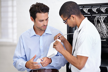 Image showing Server room, modem and connection with a technician talking to a business man about cyber security. Network router, cable or wire and consulting with an engineer chatting about information technology