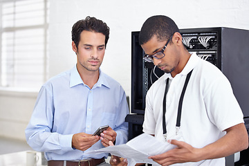 Image showing Server room, it support and reading with an engineer working with a business man for cyber security. Network, database and instructions with a male technician doing research about installation