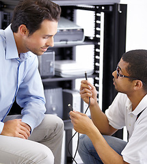 Image showing Server room, it support and cables with a technician explaining to a business man about cyber security hardware. Network, database and consulting with an engineer chatting about wire management