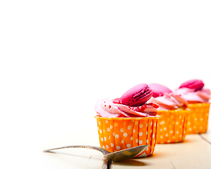 Image showing pink berry cream cupcake with macaroon on top