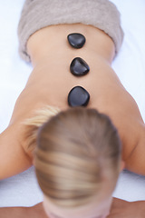 Image showing Woman getting hot stone back massage at spa, holistic treatment and stress relief, self care at luxury wellness resort. Physical therapy, bodycare with rocks for healing and zen with top view