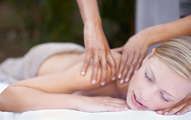 Image showing Hands of masseuse, woman getting massage in spa and wellness with peace, tranquility and holistic treatment. Stress relief, zen and female person at luxury resort with self care and body healing