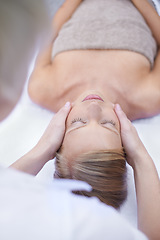 Image showing Relax, reiki and facial massage, woman in spa for health, wellness and luxury treatment with eyes closed. Beauty salon, professional skin care therapist and face of girl on table for reflexology.