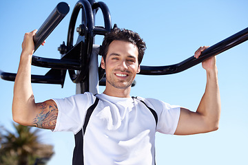 Image showing Happy man, fitness and portrait with equipment at park gym for workout, exercise or training in nature. Fit, active and strong male exercising on outdoor machine for strength or weightlifting