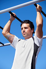 Image showing Man, fitness and pull ups on monkey bars in nature, park or outdoor gym for weightlifting, exercise or workout. Fit, active and strong male lifting body weight or hanging on iron bar for exercising