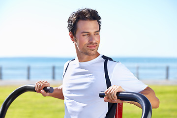 Image showing Man, fitness and shoulder press at park for workout, exercise or training in nature by the beach gym. Fit, active or strong male exercising on outdoor machine for muscle, chest or healthy cardio