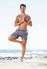 Image showing Happy man, yoga and meditation in balance on beach for spiritual wellness, zen or tree pose in nature. Male yogi standing in namaste to meditate, relax or healthy body for inner peace by the ocean