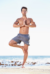 Image showing Fitness, man and yoga in meditation on beach for exercise, spiritual wellness or inner peace in nature. Calm male yogi in tree pose for balance, healthy body or mindfulness and awareness on the ocean