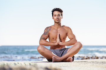 Image showing Man, relax and yoga in meditation on beach for spiritual wellness, inner peace or mental wellbeing in nature. Calm male yogi in meditate pose for balance, healthy body or mindfulness by the ocean