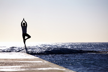 Image showing Man, silhouette and yoga in meditation on ocean at beach for spiritual wellness, inner peace or mental wellbeing space. Male yogi in tree pose for balance, healthy body or mindfulness on sea mockup