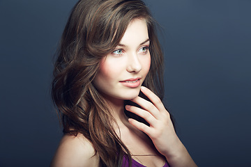 Image showing Cosmetic, makeup and woman in a studio with a natural, face and beauty routine. Self care, beautiful and young female model with cosmetics, dermatology or skincare treatment by dark background.