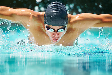 Image showing Health, sports and training with man in swimming pool for competition, workout and energy. Strong, water splash and cardio with male swimmer and practice for athlete, championship and race at gala