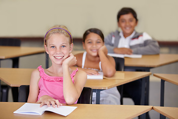 Image showing Portrait, kids and smile of student in classroom with book, ready to learn and study in class. Group of students, education and girl learning in primary school for knowledge, development or studying.