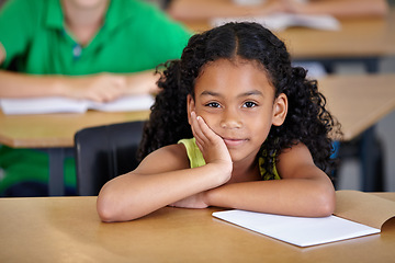 Image showing Portrait, kid and bored student in classroom with book, ready to learn and study in class. Boredom, education and serious Indian girl learning in primary school for knowledge, development or studying