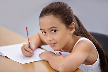 Image showing Portrait, kid and education of student taking notes in classroom for knowledge and development. Serious, girl and learner writing in notebook, studying or learning in middle school class in Spain.