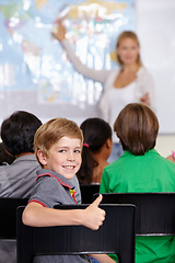 Image showing Kid, portrait and thumbs up of student in classroom, elementary school or class. Smile, education and child with hand gesture for like emoji, agreement or learning, success and sign of approval.