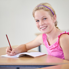 Image showing Portrait, child and education of student taking notes in classroom for knowledge, development and happy. Smile, girl and learner writing in notebook, studying or learning in middle school in Canada.