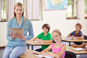 Image showing Portrait, teacher and woman with children in classroom, smile and holding folder. Happiness, female educator and students ready for learning, knowledge or studying in elementary school for education.