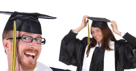 Image showing two successful student in graduation gowns 