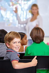 Image showing Child, portrait and thumbs up of student in classroom, elementary school or class. Smile, education and kid with hand gesture for like emoji, agreement or learning, success and approval sign.