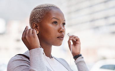 Image showing Music, thinking and vision with a business black woman in the city on her morning commute into work. Mindset, future and earphones with a young female employee streaming audio in an urban town