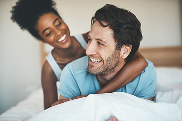 Image showing Happy couple, bed and hug laughing for morning, relax or bonding relationship at home. Interracial man and woman smiling, hugging and laugh in joyful happiness or relaxing weekend together in bedroom