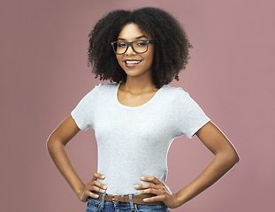 Image showing Portrait, happy and black woman with glasses akimbo in studio isolated on a pink background. Natural beauty, nerd and face of African female model from Nigeria with confidence, cosmetics and fashion.